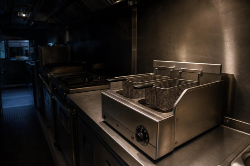 Compact countertop double fryer on a food truck prep station