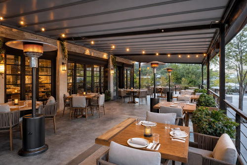Restaurant patio arranged for cool-weather service with outdoor heaters