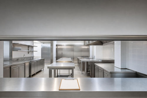 Bright unbranded commercial kitchen prepared for an opening-readiness inspection