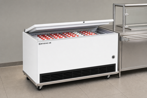 Beverage-Air SM58HC-W-02 school milk cooler stocked with half-pint milk cartons next to a stainless steel cafeteria serving line