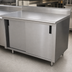Thumbnail image #3 for Advance Tabco Special Value Series Economy Enclosed Work Table with Cabinet Base, Mid-Shelf, Sliding Doors, 84 x 24 Inches, 16 Gauge 304 Stainless Steel Top, 5 Inch Backsplash