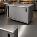 Thumbnail image #3 for Advance Tabco Enclosed Work Table, 144 x 30 Inches, Cabinet Base, Mid-Shelf, Sliding Doors, 14-Gauge 304 Stainless Steel Top