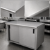 Thumbnail image #3 for Advance Tabco Special Value Series Enclosed Work Table with Cabinet Base, Mid-Shelf and Sliding Doors, 108 x 24 Inches, 16 Gauge 304 Stainless Steel Top