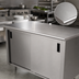 Thumbnail image #3 for Advance Tabco CB-SS-3610M 120-Inch x 36-Inch Enclosed Work Table with Cabinet Base, Mid-Shelf, Sliding Doors, and 14 Gauge 304 Stainless Steel Top