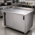 Thumbnail image #3 for Advance Tabco 84 Inch x 30 Inch Enclosed Work Table with Cabinet Base, Mid-Shelf, Sliding Doors, and 14-Gauge 304 Stainless Steel Top
