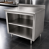 Thumbnail image #4 for Advance Tabco 84-Inch x 24-Inch 14-Gauge 304 Stainless Steel Work Table with Open Front Cabinet Base, Mid-Shelf, and 5-Inch Backsplash