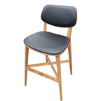 Thumbnail image #1 for Oak Street Harbor BW-0234-NT-BLK Commercial Bar Stool, Armless, Black Vinyl Upholstered Seat and Back, Natural-Finish Wood Frame, Footrest