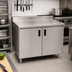 Thumbnail image #2 for Advance Tabco Special Value Series 48-Inch x 24-Inch Enclosed Work Table with Cabinet Base, 16 Gauge 304 Stainless Steel Top, and 5-Inch Backsplash