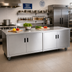 Thumbnail image #2 for Advance Tabco Enclosed Work Table with Cabinet Base, Mid-Shelf and Hinged Doors, 72 x 36 Inch, 14 Gauge 304 Stainless Steel Top