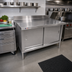 Thumbnail image #2 for Omcan 60-Inch x 30-Inch 430 Stainless Steel Enclosed Work Table with Cabinet Base, Sliding Doors, and 4-Inch Backsplash
