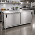 Thumbnail image #2 for Advance Tabco Enclosed Work Table with Sliding Doors, 120 Inch W x 24 Inch D, 14 Gauge 304 Stainless Steel Top