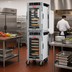 Thumbnail image #3 for Metro HotBlox Narrow Dual-Cavity Pass-Thru Insulated Holding Cabinet, 16-Pan, Analog, Clear Front & Rear Doors, Mobile