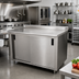 Thumbnail image #2 for Advance Tabco 144-Inch Enclosed Stainless Steel Work Table with Sliding Doors, 14-Gauge Top and 1-1/2-Inch Rear Up-Turn