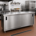 Thumbnail image #2 for Advance Tabco 144-Inch x 24-Inch 14-Gauge 304 Stainless Steel Enclosed Work Table with Cabinet Base, Mid-Shelf, and Sliding Doors