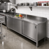 Thumbnail image #2 for John Boos Enclosed Stainless Steel Work Table with Hinged-Door Cabinet Base, 132 x 30 Inches, 14-Gauge 300 Series Top, 5-Inch Backsplash