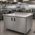 Thumbnail image #2 for Advance Tabco 84-Inch Enclosed Work Table with Cabinet Base, Mid-Shelf, Hinged Doors, and 304 Stainless Steel Top