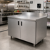 Thumbnail image #2 for Advance Tabco 72-Inch x 36-Inch Enclosed Work Table with Cabinet Base and Hinged Doors, 14-Gauge 304 Stainless Steel Top, and 5-Inch Backsplash