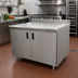 Thumbnail image #2 for Advance Tabco Special Value Economy Enclosed Work Table with Hinged Door Cabinet Base, 60 x 24 Inches, 16 Gauge 304 Stainless Steel Top, 5 Inch Backsplash