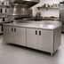 Thumbnail image #2 for Advance Tabco 144 Inch x 36 Inch Enclosed Work Table with Cabinet Base, Mid-Shelf, Hinged Doors, and 14 Gauge 304 Stainless Steel Top