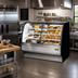 Thumbnail image #2 for True 59-1/4 Inch Dual Zone Dry/Refrigerated Curved Glass Full-Service Floor Merchandiser, Stainless Steel, Self-Contained R290