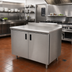 Thumbnail image #2 for Advance Tabco 48-Inch x 24-Inch Enclosed Stainless Steel Work Table with Cabinet Base, Mid-Shelf and Hinged Doors