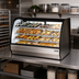 Thumbnail image #2 for True 59-1/4-Inch Dry Curved Glass Pastry Display Case with Stainless Steel Exterior and White Interior